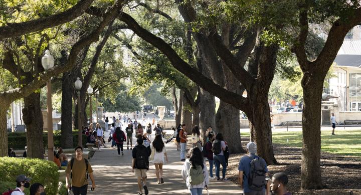 Student walking in the shade on the UT Austin campus